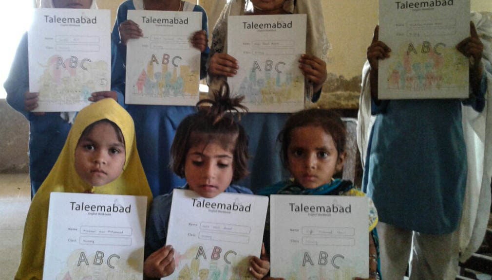 Students in Pakistan with the books that accompany Orenda's educational Taleemabad cartoon program