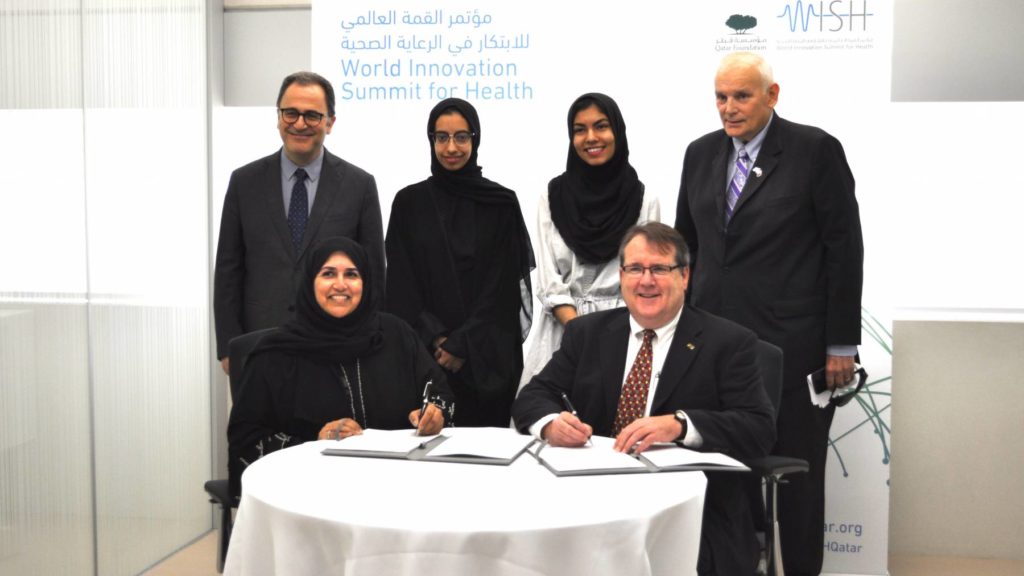 GU-Q Dean Dr. Ahmad S Dallal and GU-Q Senior Asma Al Jehani along with NU-Q Dean Everette E Dennis and NU-Q student Ayilah Chaudhary