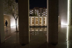 Two poles with light up parts of building in Msheireb in the evening light.