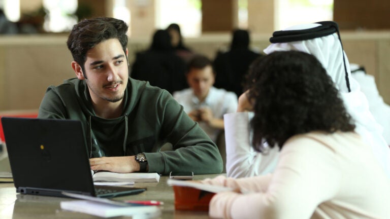 Students around a laptop