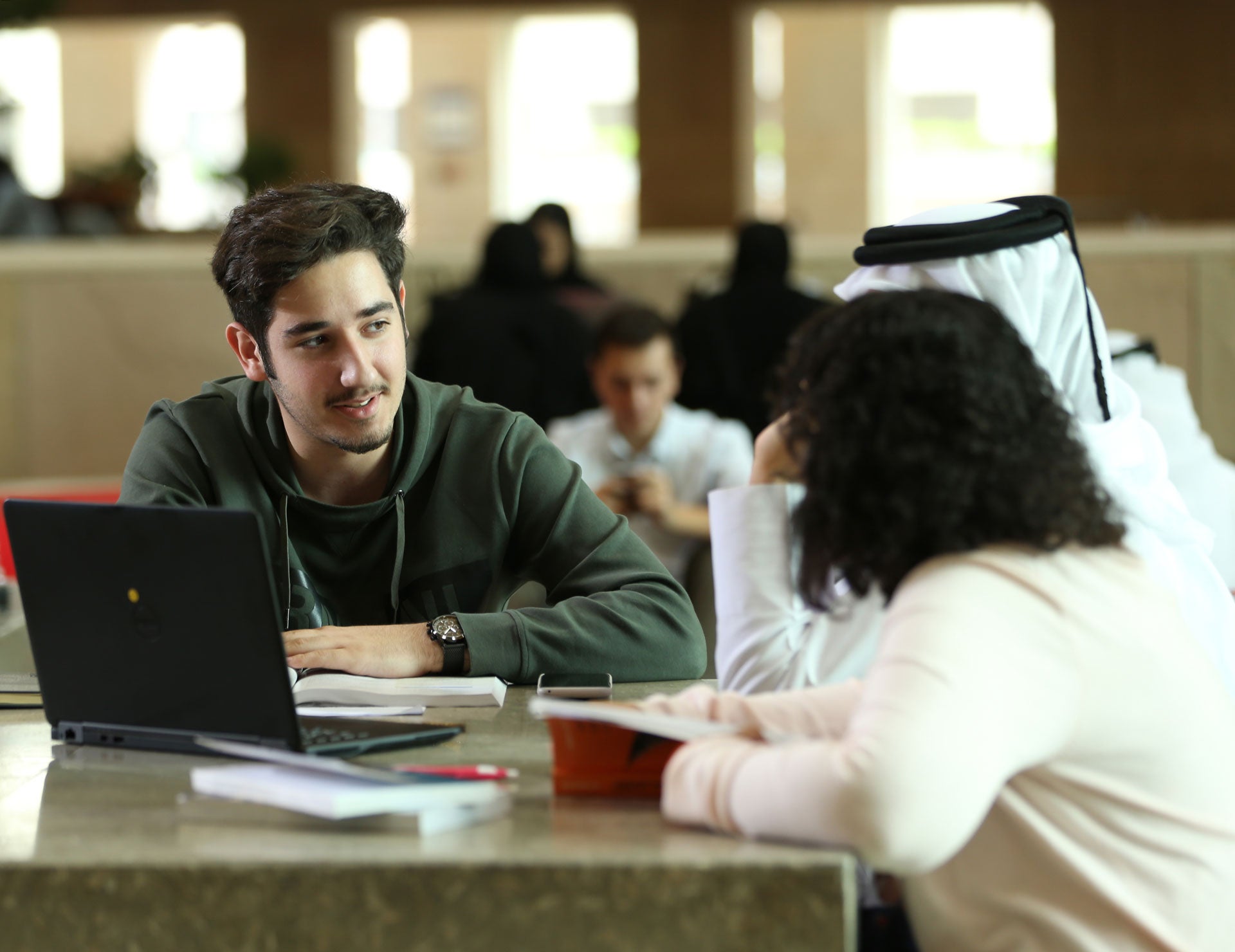 Students around a laptop