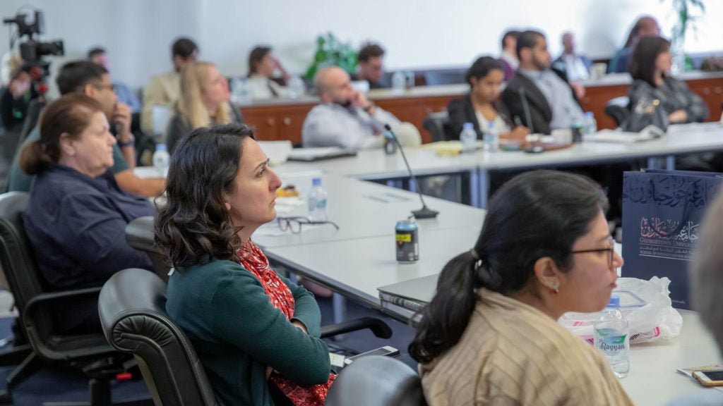 Scholars concentrating on the speaker's talk at the IOWG conference