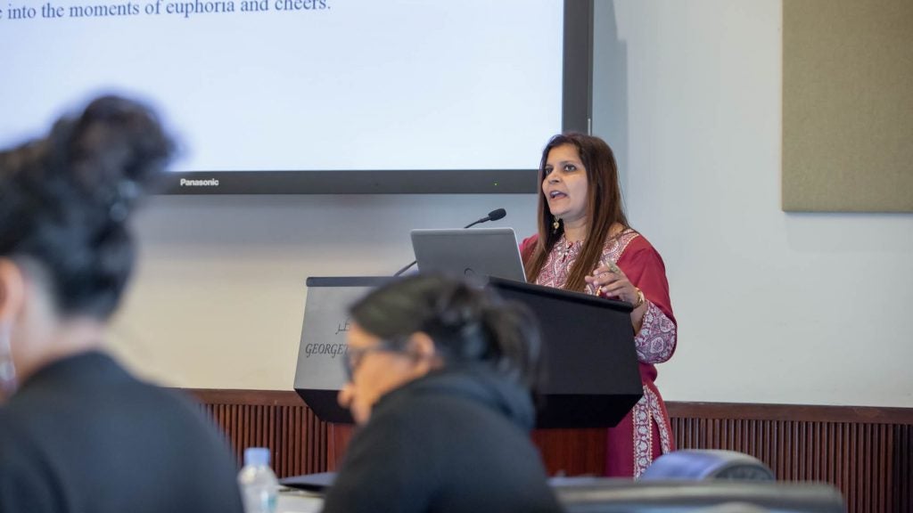 A speaker presenting her talk at the IOWG conference