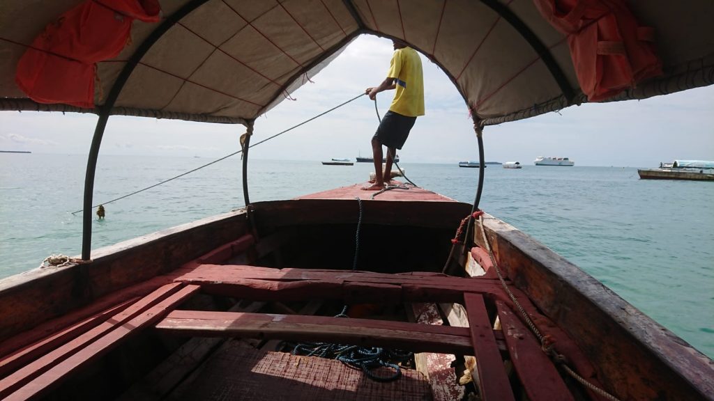 A boatman sailing his boat in Zanzibar