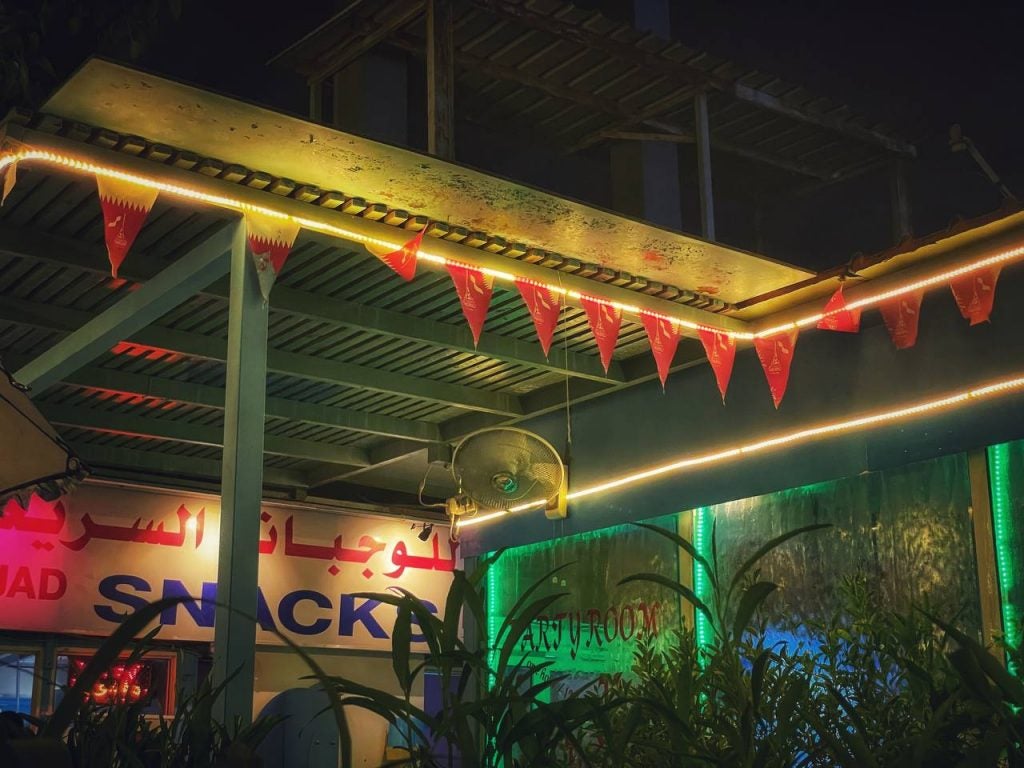 Buddhist prayer flags hanging below the Thai Snack restaurant's roof