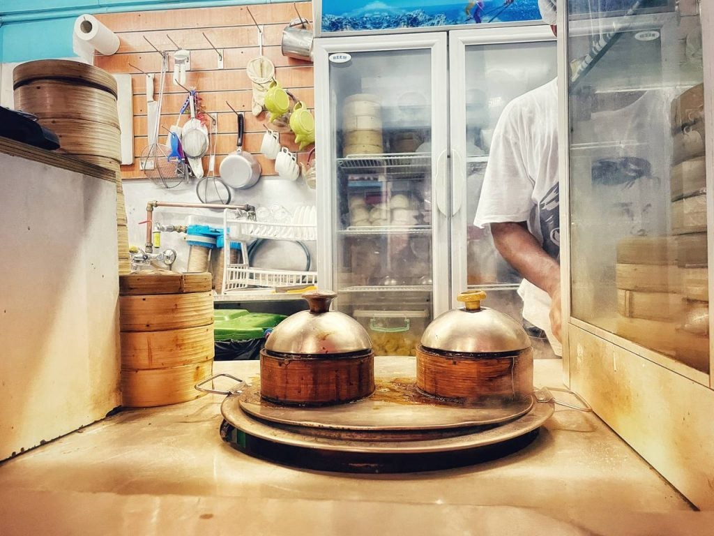 Dumplings being steamed in the kitchen in the bamboo baskets