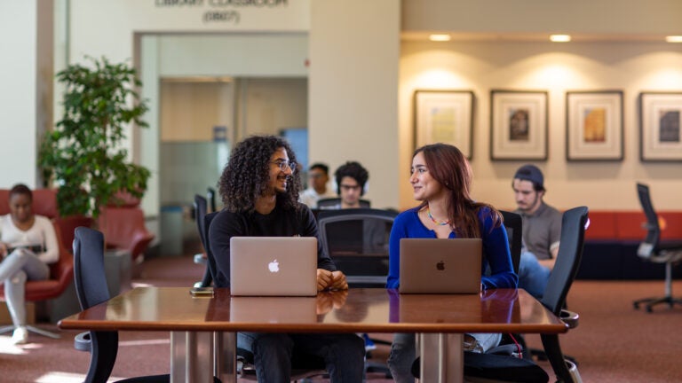 Image of Students Interacting in a Library