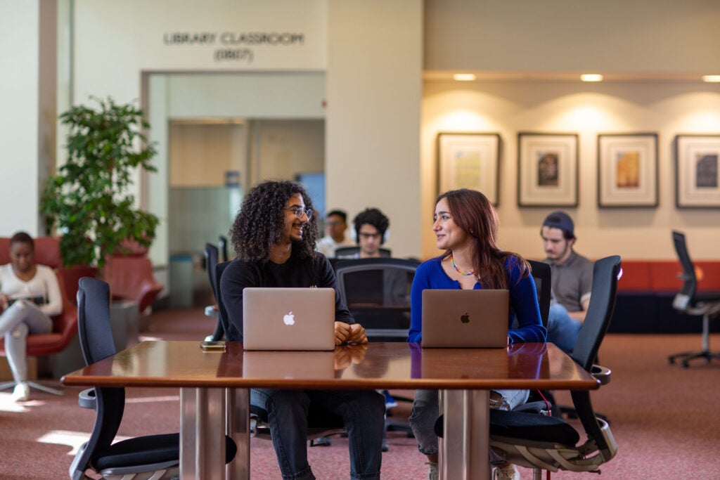 Image of Students Interacting in a Library