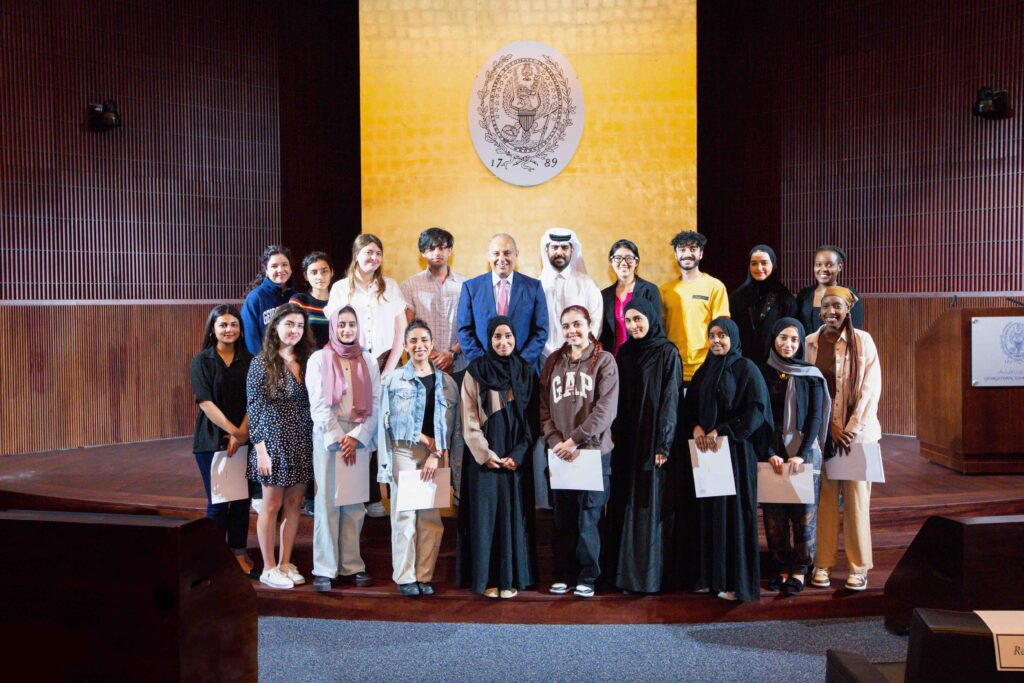 Dean's reception for honor students.Students on stage with the dean. 