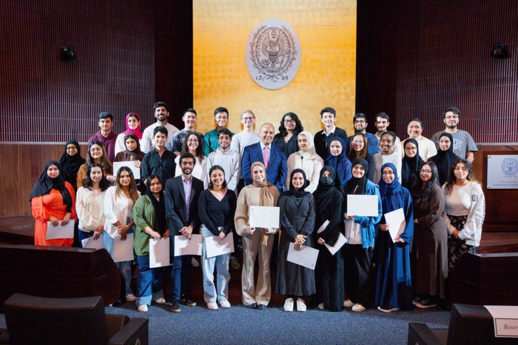 Dean's reception for honor students.Students on stage with the dean. 