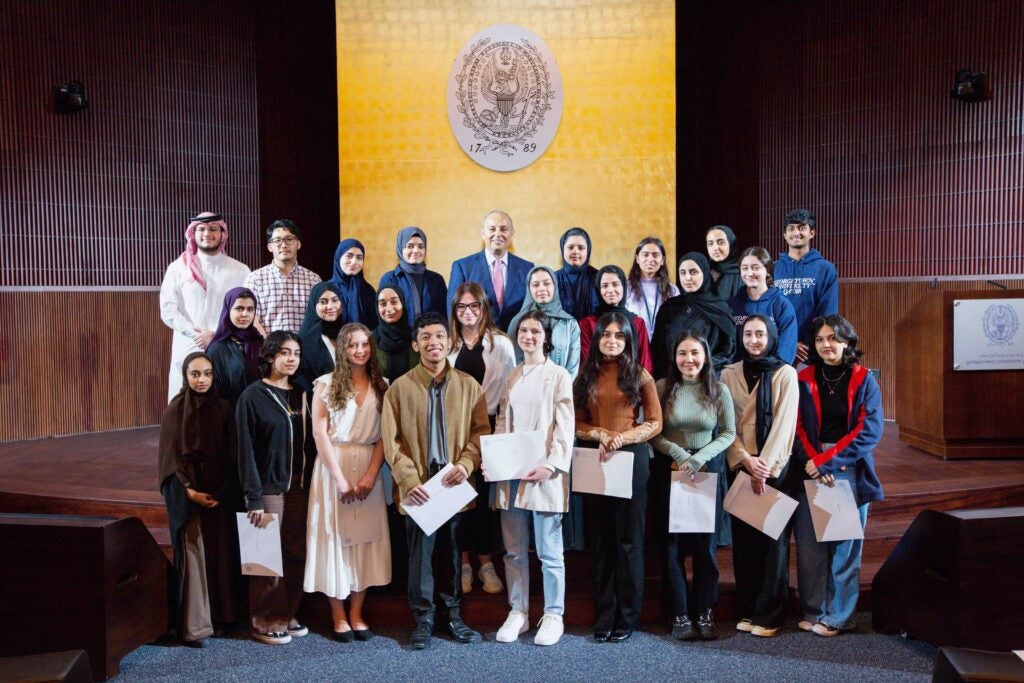 Dean's reception for honor students.Students on stage with the dean. 