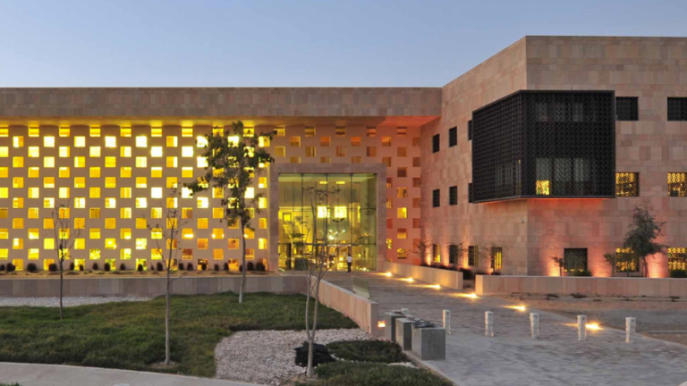 Image of the Georgetown University in Qatar at dusk with the building lights on