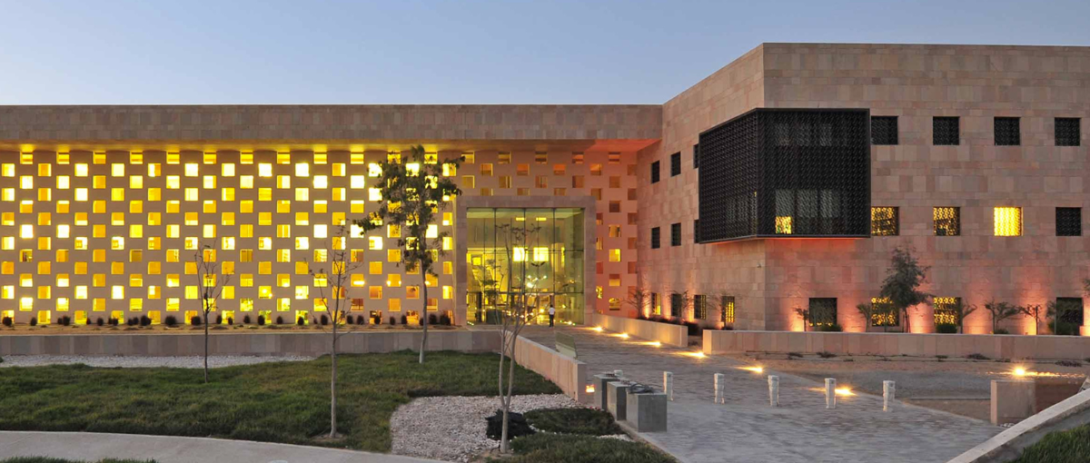 Image of the Georgetown University in Qatar at dusk with the building lights on